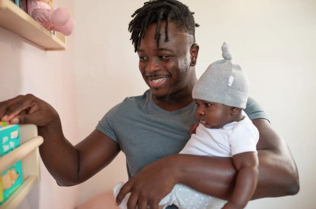 Father holding baby looking at products