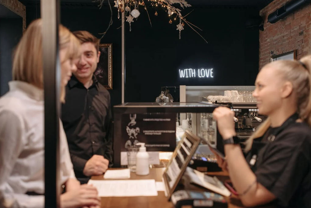 Cashier interacting with happy customers at point of sales